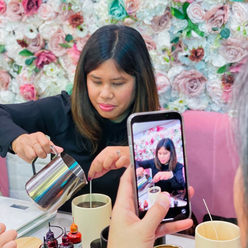 a person sitting at a table with a cup of coffee