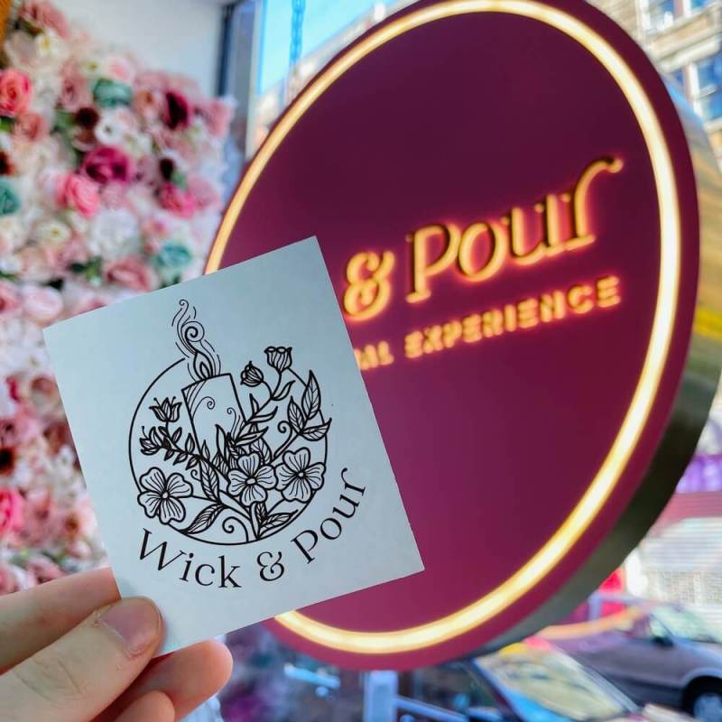 a hand holding up a sign