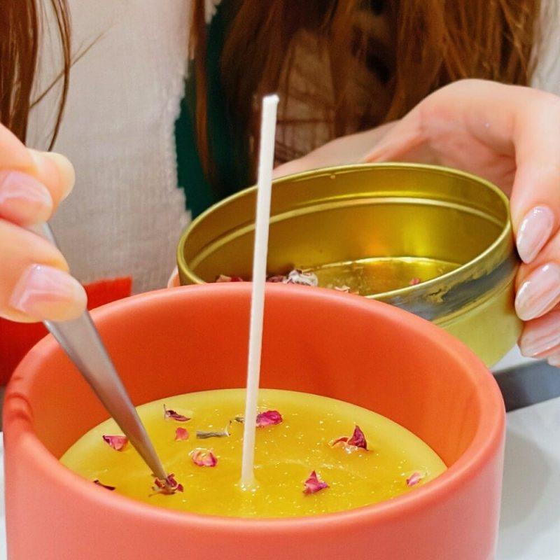 a woman standing in front of a bowl of soup